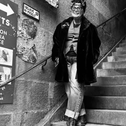 Gilly standing on a stairway